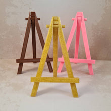 Load image into Gallery viewer, Mini easels for artworks and paintings in Hot Pink, Rustic Brown, Natural Pine and Glittery Gold
